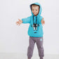 Cute boy wearing Baby Jumper Robot 232, a blue pull-over with a cute robot print.