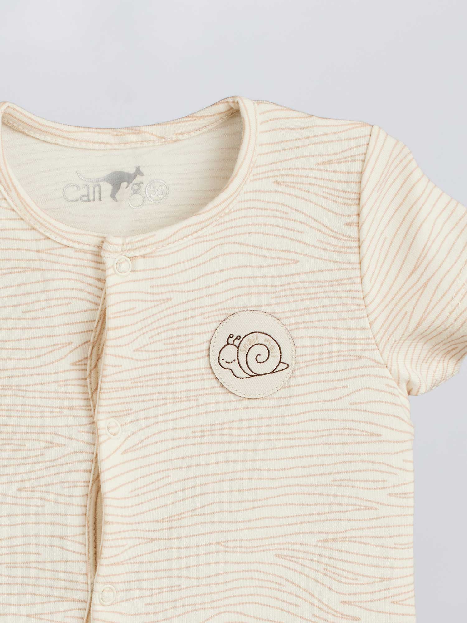 The infant overall has a cute snail logo print and warm colors