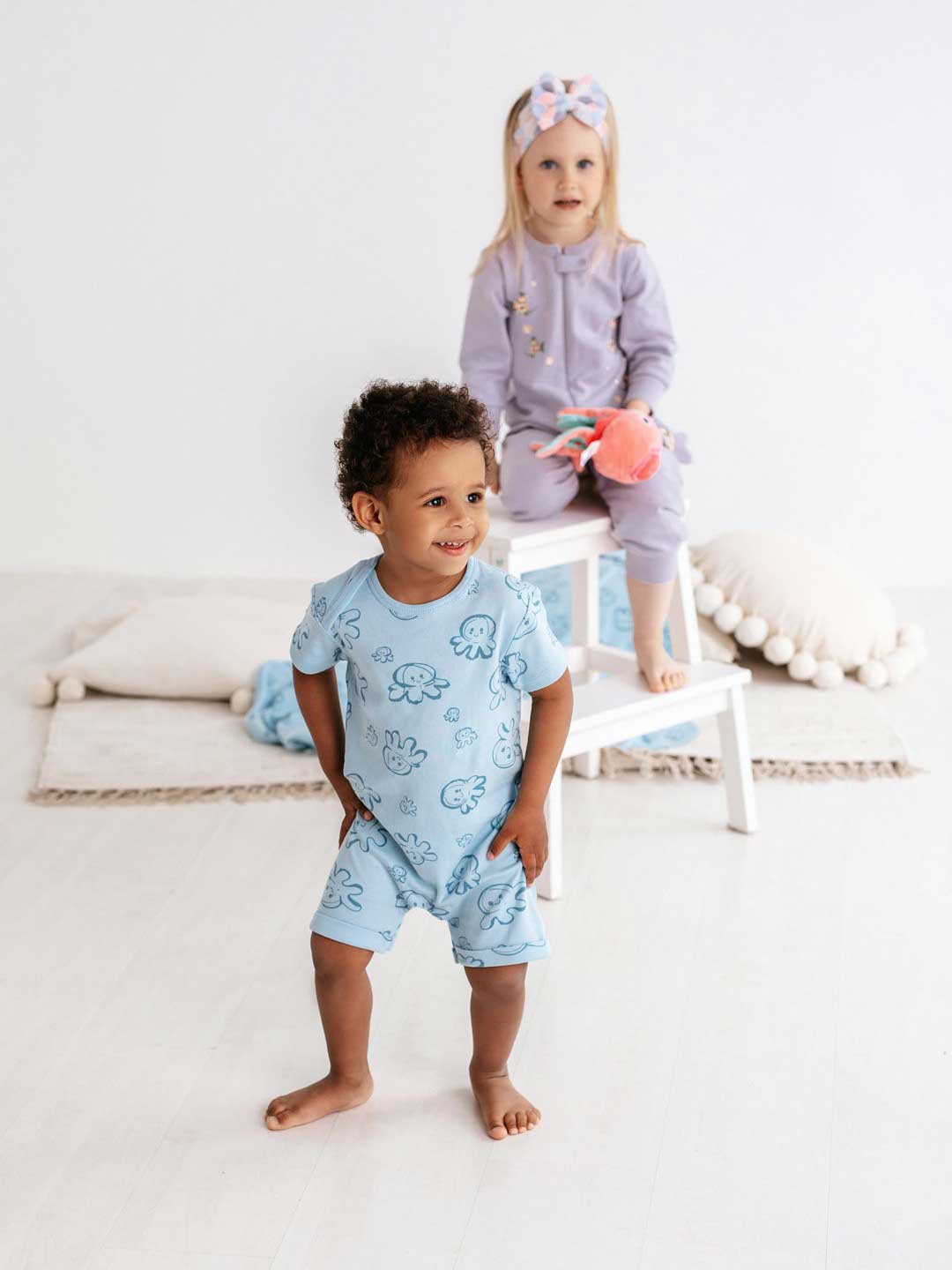 Cute boy and girl playing. The boy wears Infant Overall Short Sea Friends 344 and the girl wears  Infant Overall Squirell